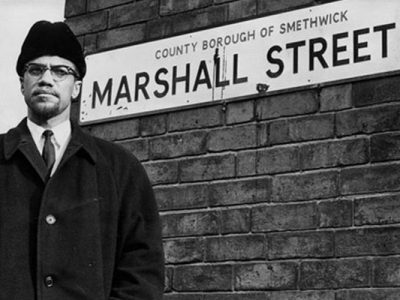 Malcolm X standing in Marshall Street, in Smethwick